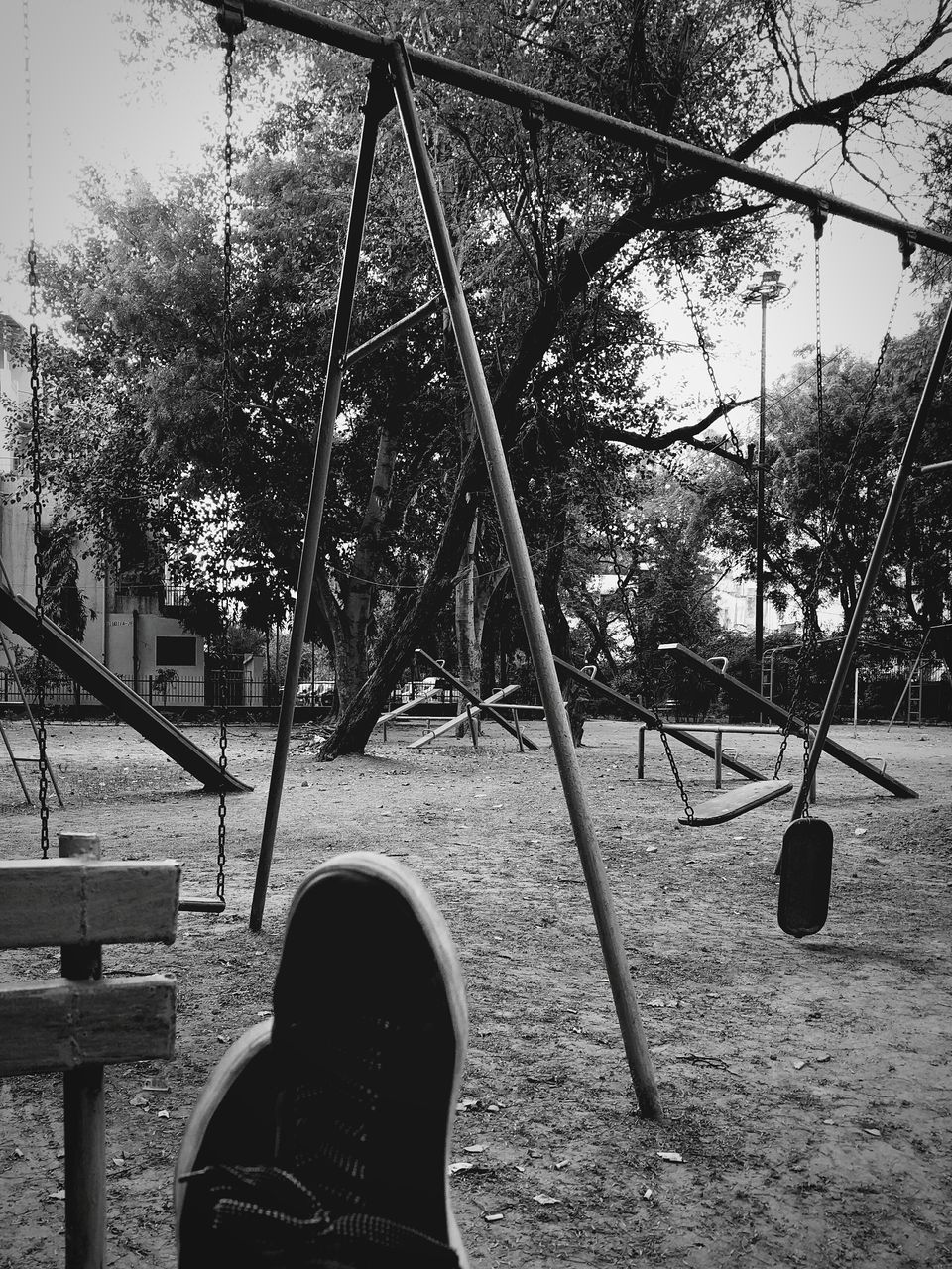 tree, leisure activity, lifestyles, men, personal perspective, low section, park - man made space, unrecognizable person, shoe, sky, swing, day, outdoors, person, playground, relaxation