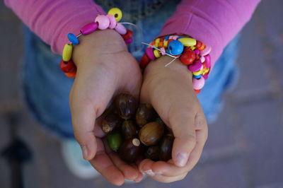 Midsection of child holding nuts