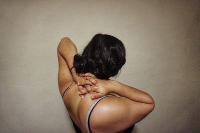 Rear view of a woman against white background