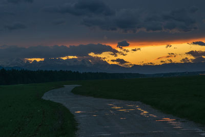 Scenic view of field against sky during sunset