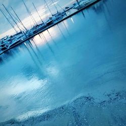 Sailboats in swimming pool against blue sky