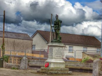 Low angle view of statue against cloudy sky