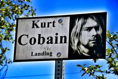 Low angle view of text against clear blue sky