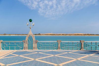 View of swimming pool by sea against sky