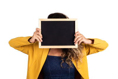 Midsection of woman holding umbrella against white background