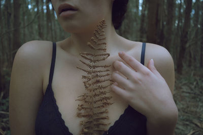 Midsection of woman in a forest