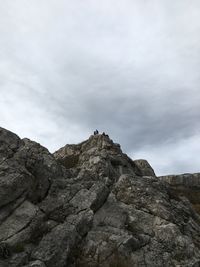 Low angle view of rocks on mountain against sky