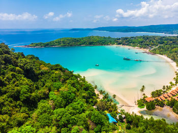 High angle view of sea and trees against sky