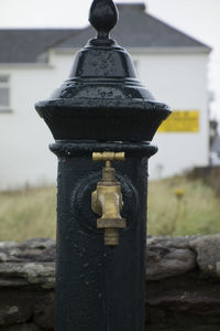 Close-up of fire hydrant against building