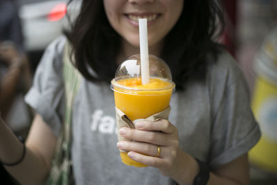 Close-up of woman drinking juice