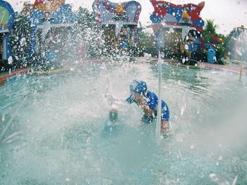 View of men swimming in pool