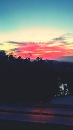 Scenic view of silhouette landscape against sky at sunset