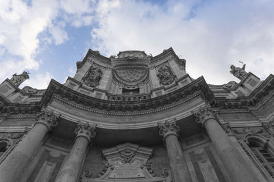 Low angle view of historical building against cloudy sky