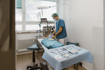 Male veterinarian surgeon preparing for surgery in medical clinic