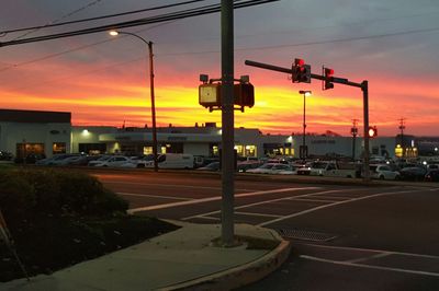 Traffic on road at sunset