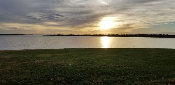 Scenic view of lake against sky during sunset