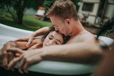 Midsection of couple holding hands