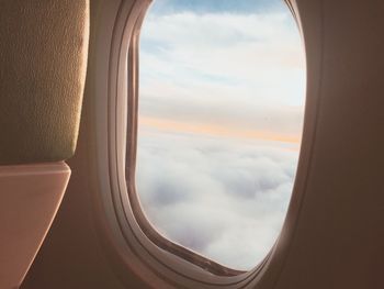 View of cloudy sky seen through airplane window