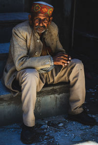 Portrait of man sitting outdoors