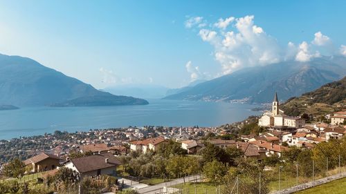 High angle view of townscape by sea against sky