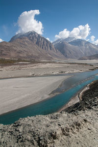 Scenic view of mountains against cloudy sky