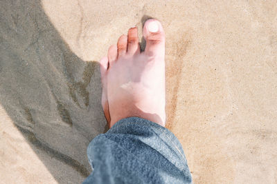 Low section of person on sand