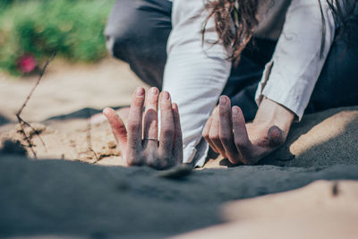 Close-up of man sitting on rock