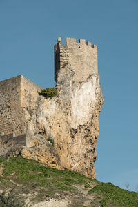 Low angle view of fort against blue sky