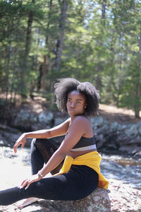 Portrait of young woman sitting in water