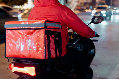 Rear view of man standing on road in city