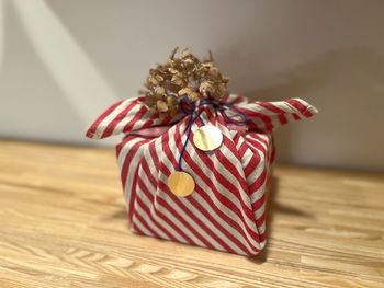 Close-up of red wrapped in box on table