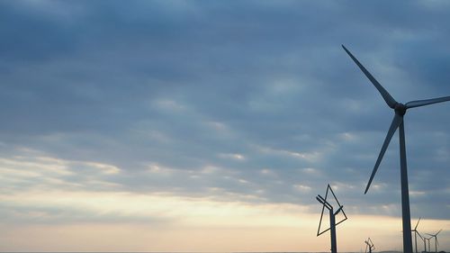 Low angle view of windmill against sky