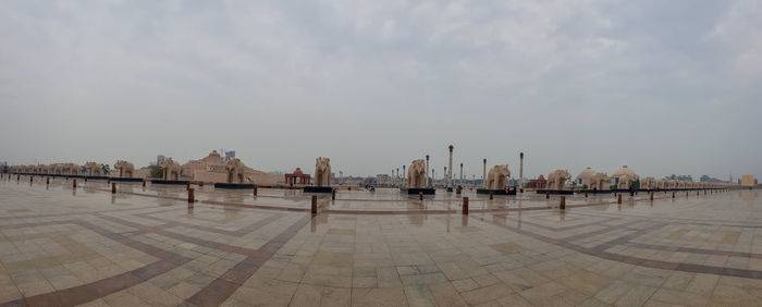 Panoramic view of beach and buildings against sky