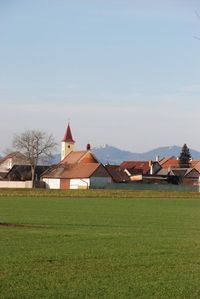 House on field against clear sky