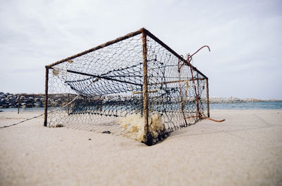 Abandoned built structure at beach against sky