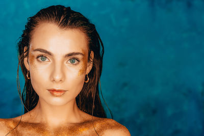 Close-up portrait of young woman in swimming pool