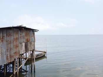 Scenic view of calm sea against cloudy sky