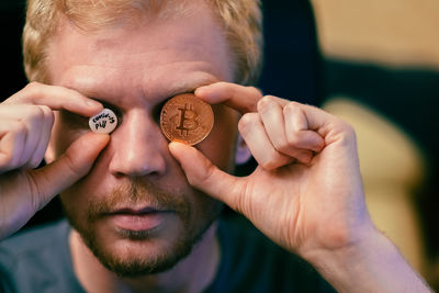 Close-up of man holding bitcoin
