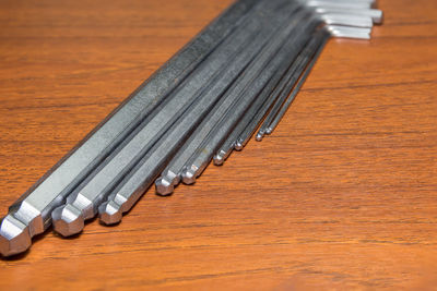 Close-up of metal tools on wooden table