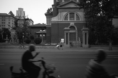 Blurred motion of people on street in city