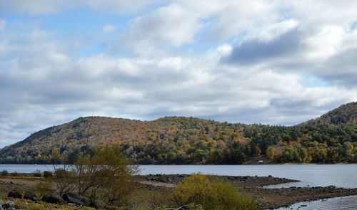 Scenic view of lake and mountains against sky