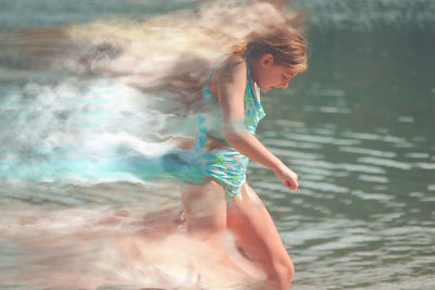Full length of woman standing in sea