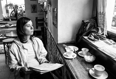 Young woman sitting at table