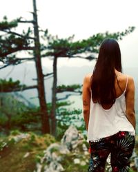 Rear view of woman standing against sky