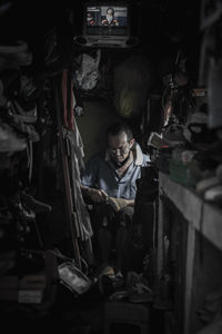 Portrait of man holding shop