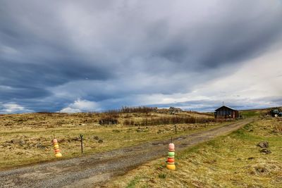 Road by landscape against sky