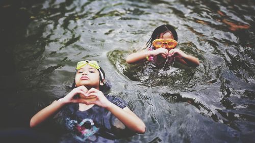 Portrait of happy girl playing in water