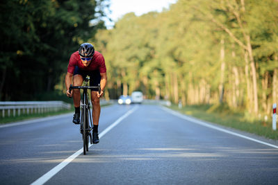 Man riding bicycle on road