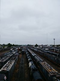 High angle view of train on railroad tracks in city against sky