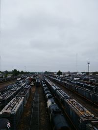 High angle view of train on railroad tracks in city against sky